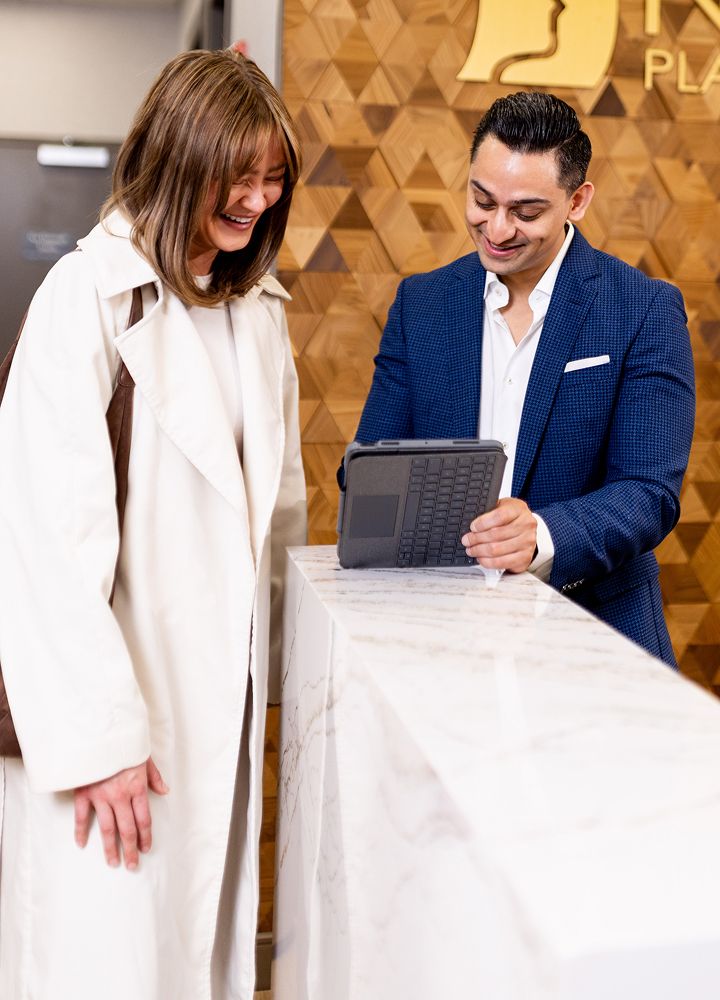Two people enjoying a conversation at a reception.