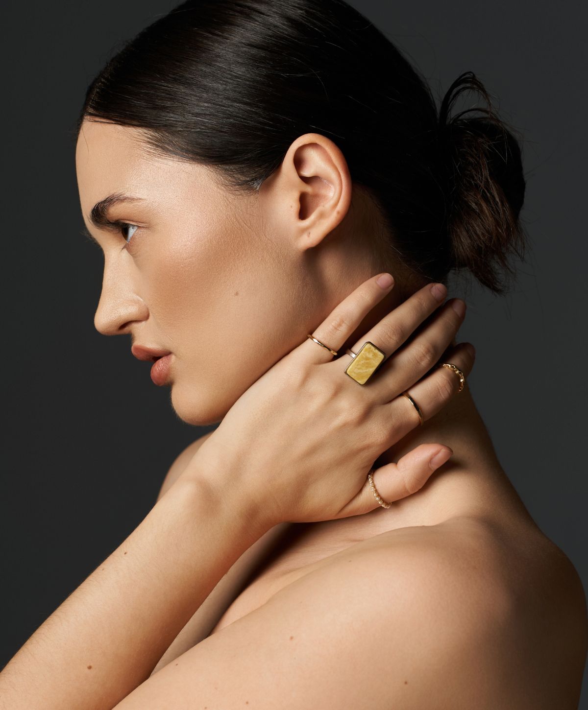 Model showcasing elegant jewelry in profile.