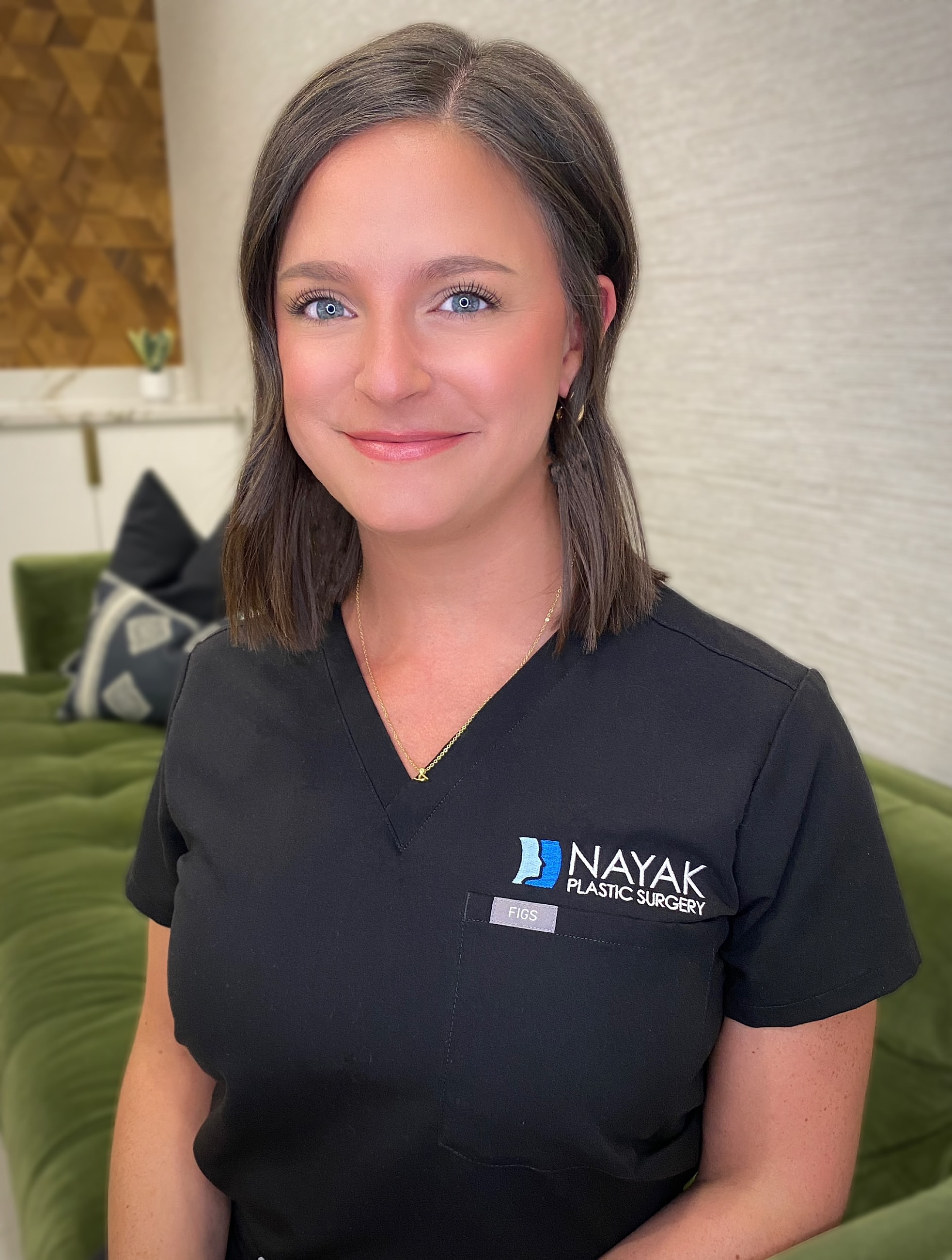 Female medical professional in plastic surgery attire.