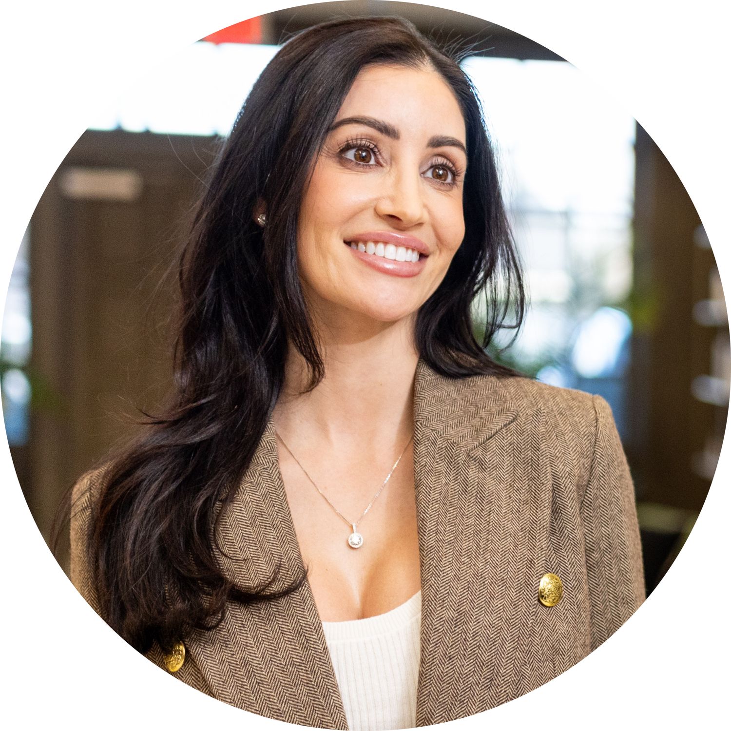 Smiling woman with long black hair in blazer