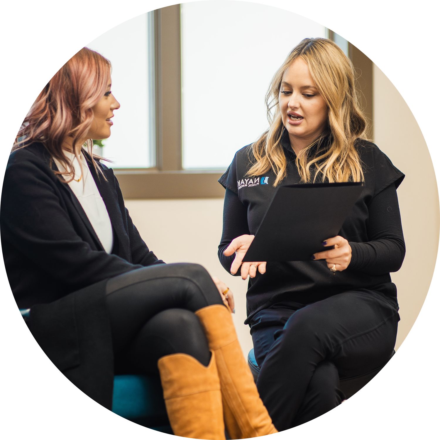 Two women in discussion with documents.