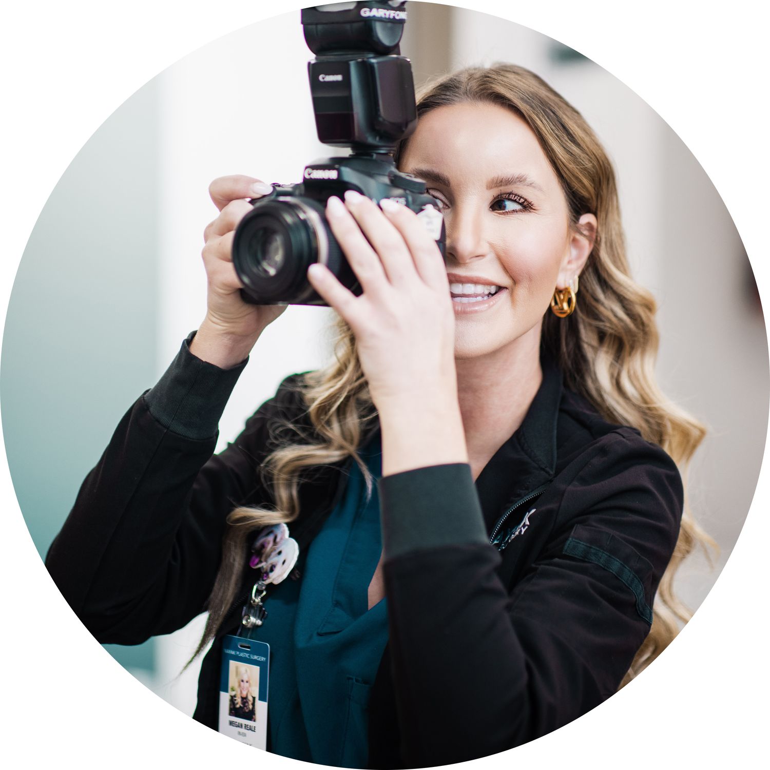 Woman smiling while taking photos with camera.