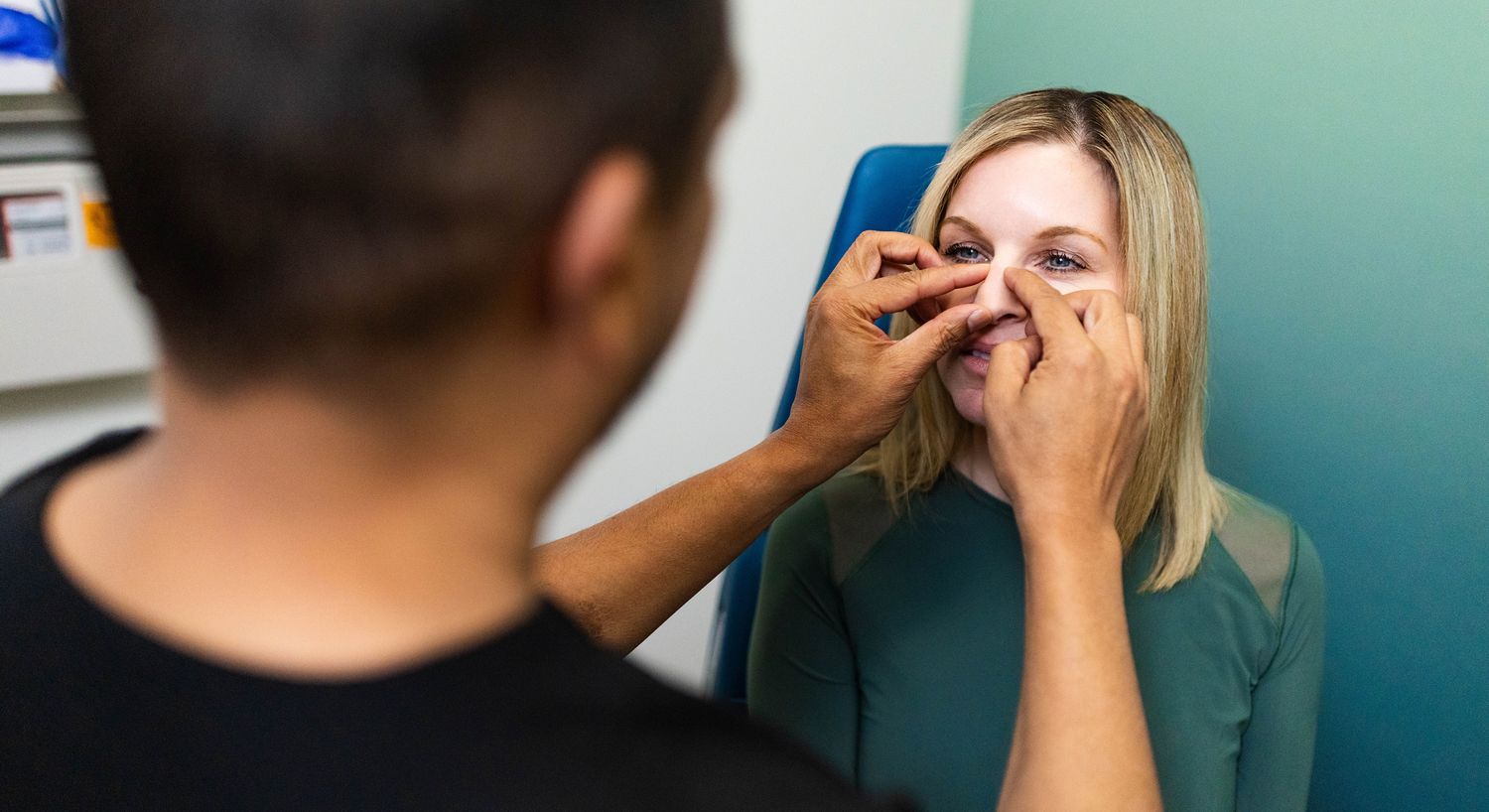 Person receiving a cosmetic facial treatment session.