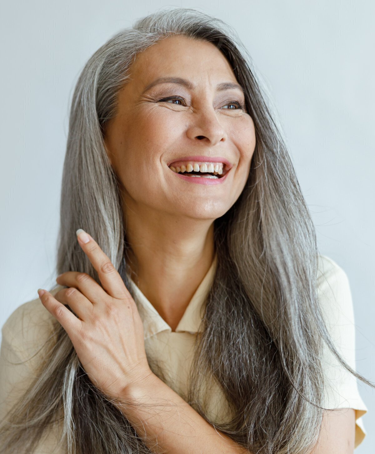 Elderly woman touching her hair