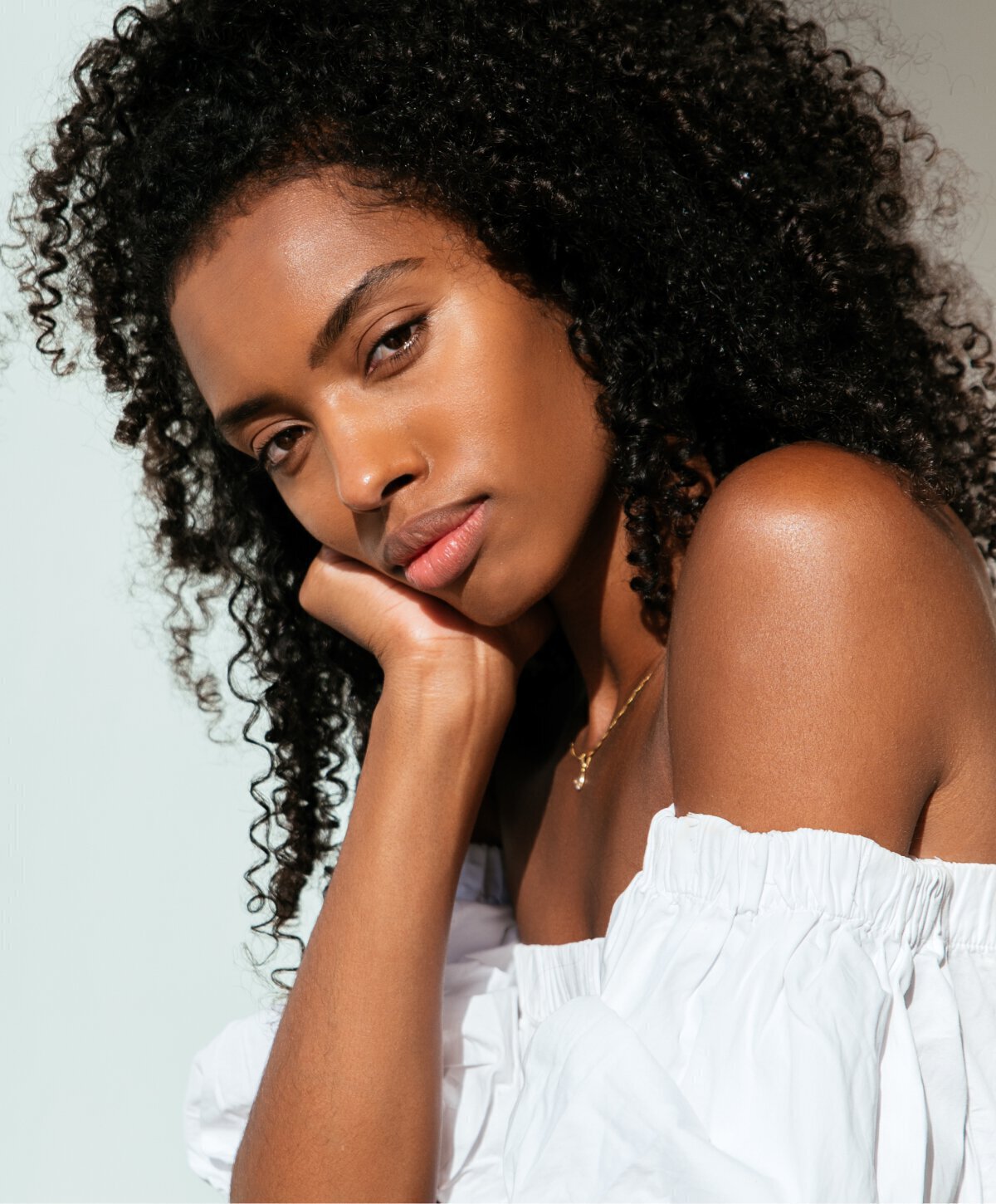 St. Louis Brow Lift model wearing a white blouse